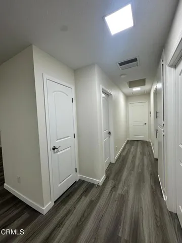 a spacious bathroom with a toilet sink double vanity and mirror