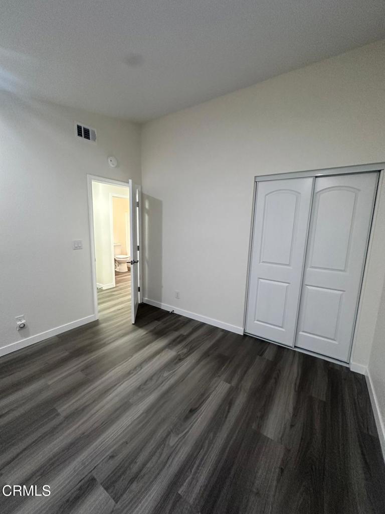 44839 16th Street East Lancaster, CA 93535 - Photo 35 of 53 a view of an empty room with wooden floor and closet