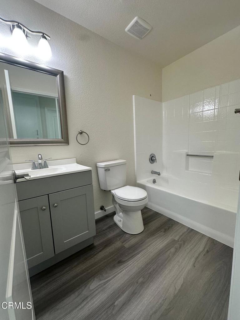 44839 16th Street East Lancaster, CA 93535 - Photo 36 of 53 a spacious bathroom with a toilet sink double vanity and mirror