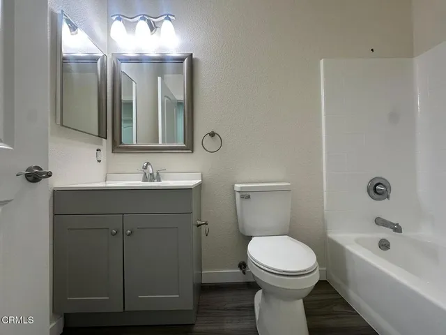 a bathroom with a double vanity sink and mirror