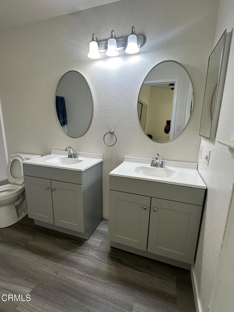 44839 16th Street East Lancaster, CA 93535 - Photo 39 of 53 a bathroom with a double vanity sink and a mirror