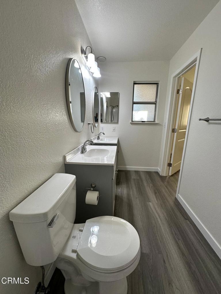 44839 16th Street East Lancaster, CA 93535 - Photo 43 of 53 a bathroom with a toilet sink and mirror