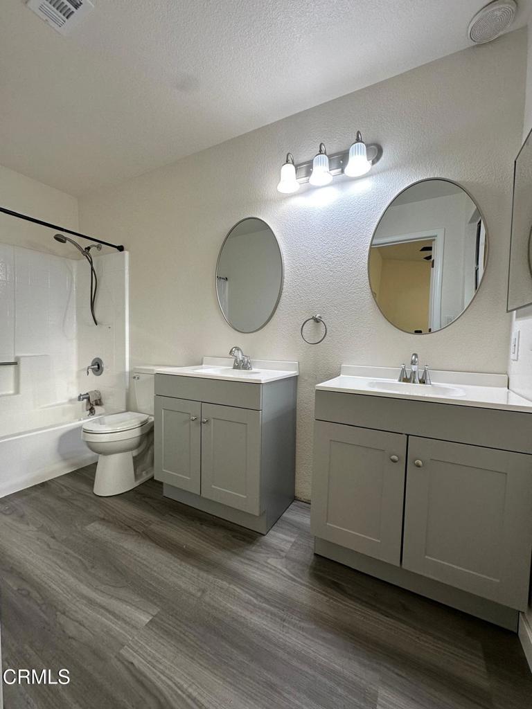 44839 16th Street East Lancaster, CA 93535 - Photo 45 of 53 a bathroom with a toilet sink double vanity and mirror