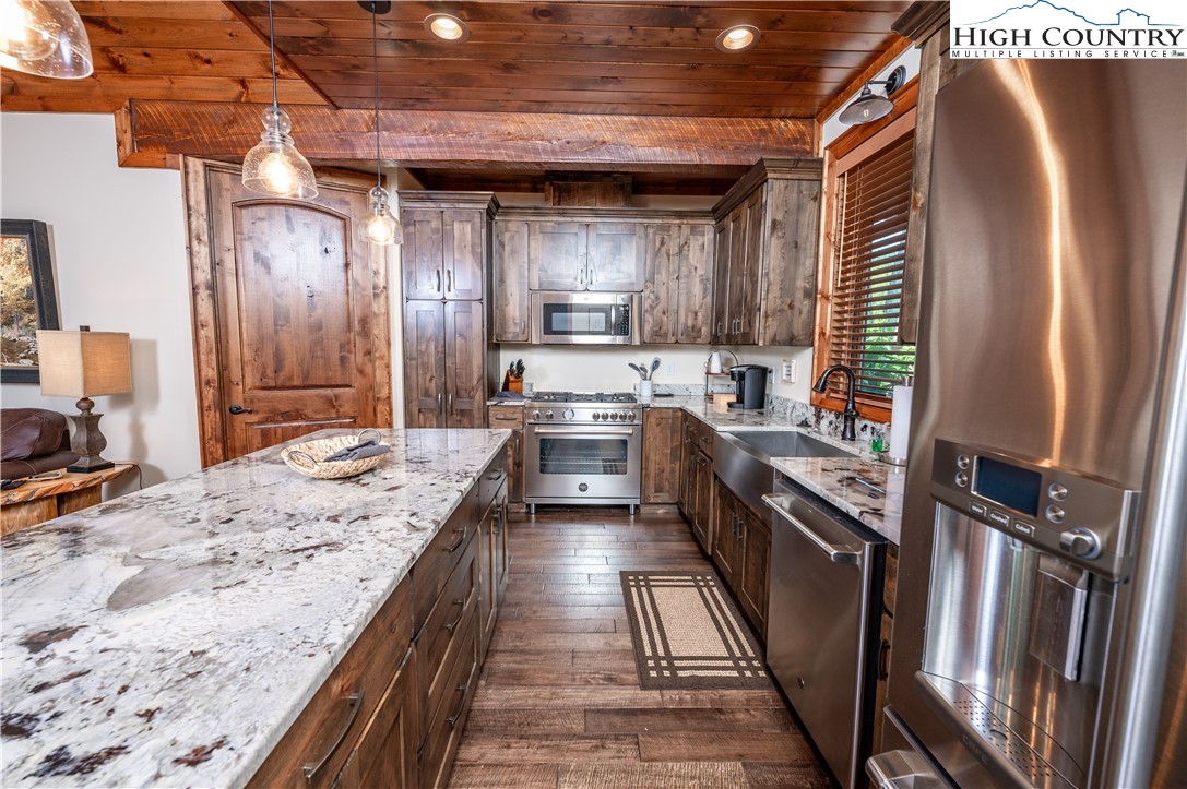 16 Camp Eagle Loop Banner Elk, NC 28604 - Photo 13 of 23 a kitchen with stainless steel appliances granite countertop sink stove refrigerator and cabinets