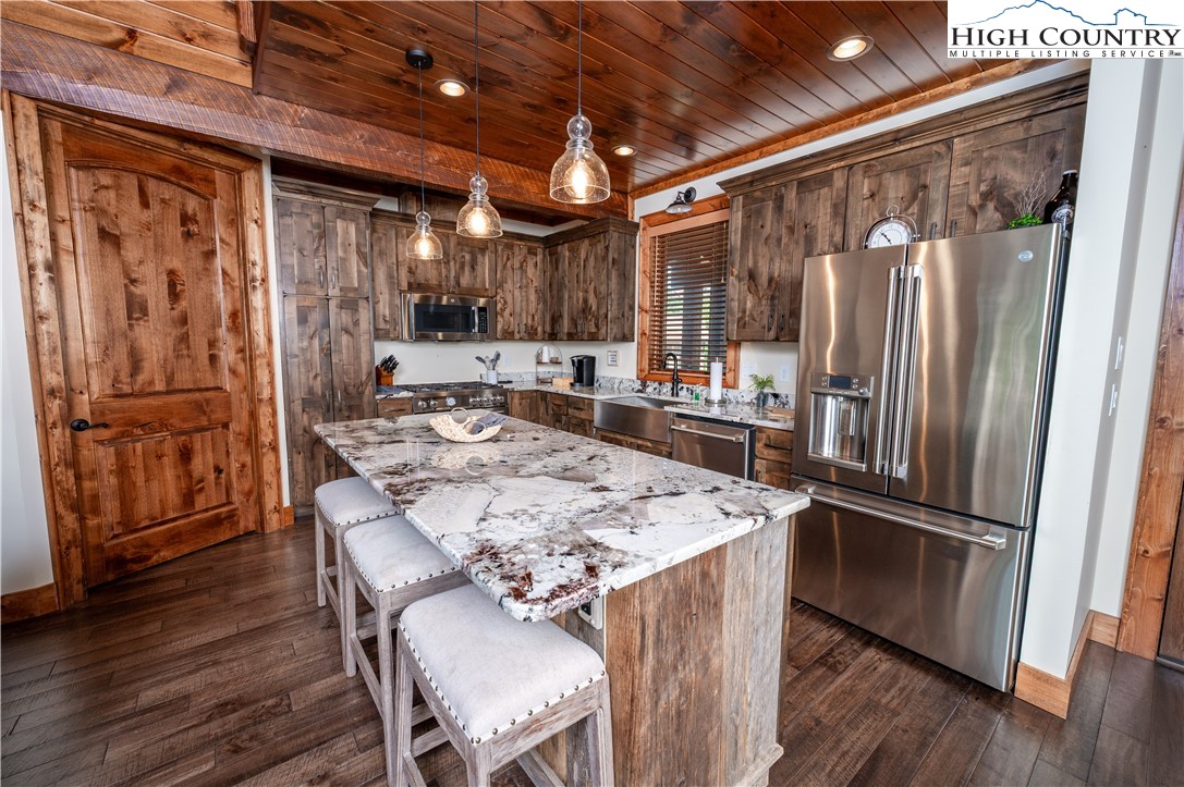 16 Camp Eagle Loop Banner Elk, NC 28604 - Photo 14 of 23 a kitchen with stainless steel appliances granite countertop a refrigerator a stove and a wooden floors
