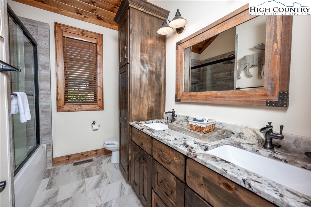 16 Camp Eagle Loop Banner Elk, NC 28604 - Photo 20 of 23 a bathroom with a granite countertop sink and a mirror