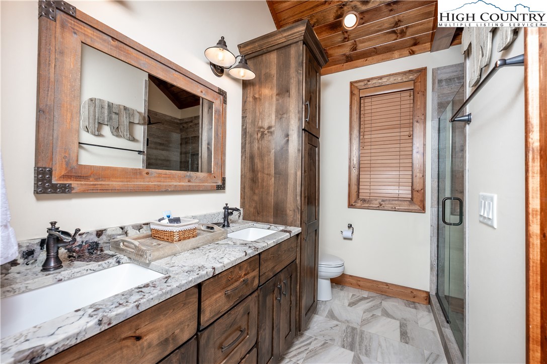 16 Camp Eagle Loop Banner Elk, NC 28604 - Photo 23 of 23 a bathroom with a granite countertop sink and a mirror