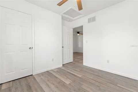 an empty room with wooden floor and closet