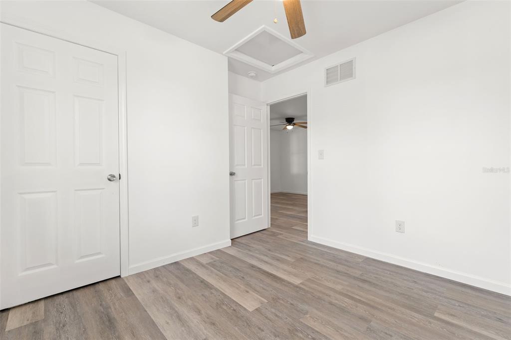 3723 Temple Street Tampa, FL 33619 - Photo 16 of 28 an empty room with wooden floor and closet