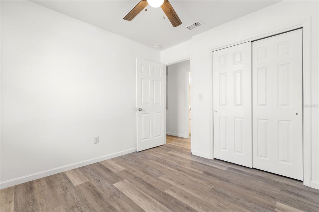 3723 Temple Street Tampa, FL 33619 - Photo 17 of 28 a view of an empty room with wooden floor