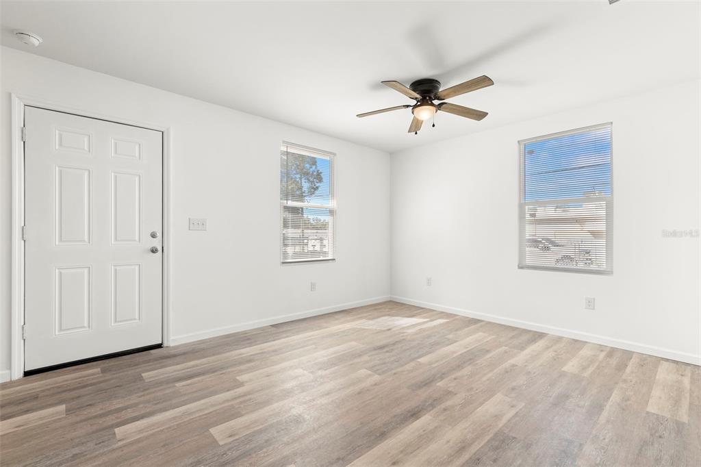 3723 Temple Street Tampa, FL 33619 - Photo 19 of 28 an empty room with windows and fan