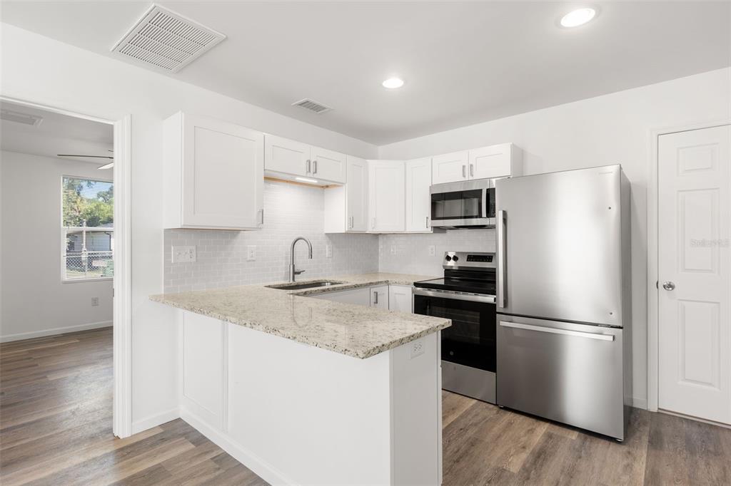 3723 Temple Street Tampa, FL 33619 - Photo 20 of 28 a kitchen with a refrigerator sink and microwave