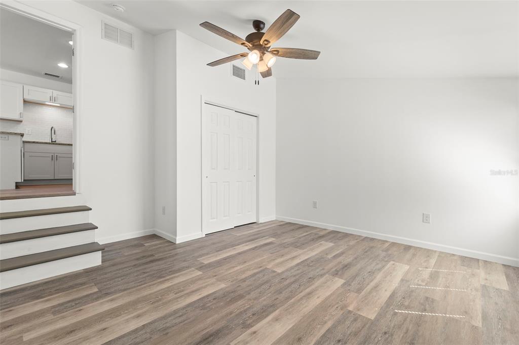 3723 Temple Street Tampa, FL 33619 - Photo 22 of 28 a view of a room with wooden floor and a ceiling fan