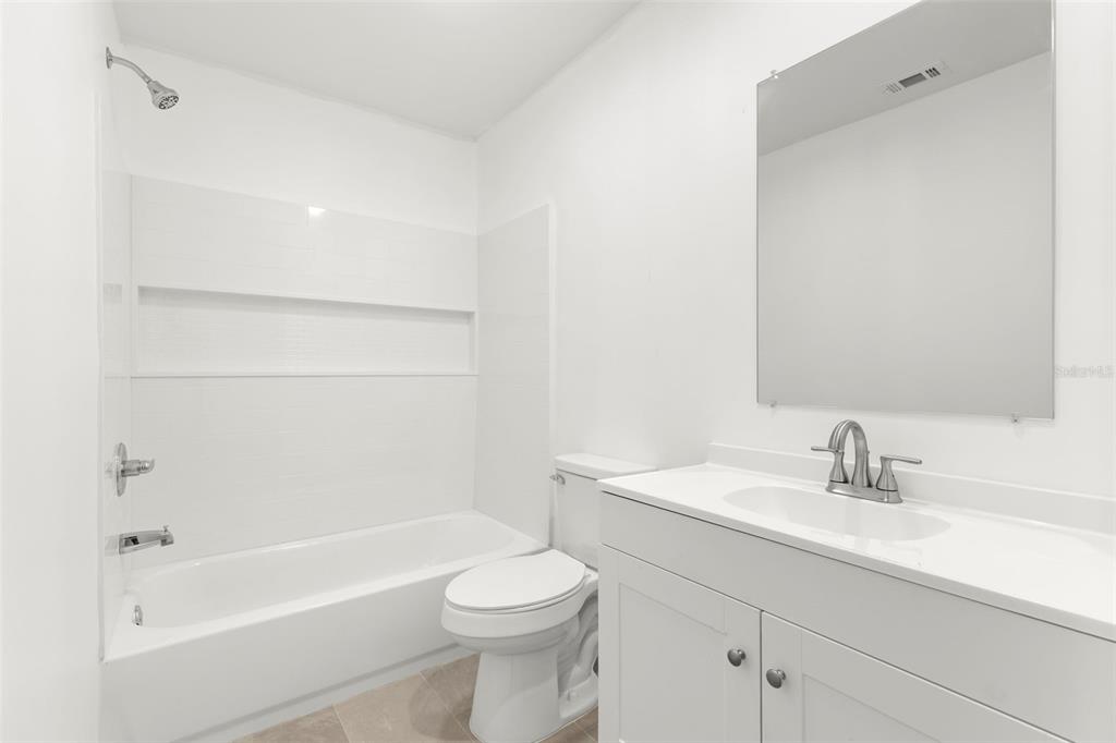 3723 Temple Street Tampa, FL 33619 - Photo 24 of 28 a bathroom with a bathtub shower sink vanity and toilet