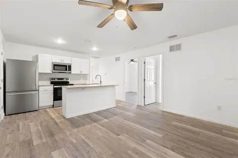 a kitchen with stainless steel appliances a refrigerator and a stove top oven