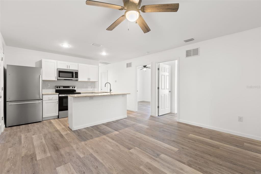 3723 Temple Street Tampa, FL 33619 - Photo 5 of 28 a kitchen with stainless steel appliances a refrigerator and a stove top oven