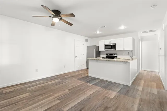 a view of kitchen with microwave and white cabinets