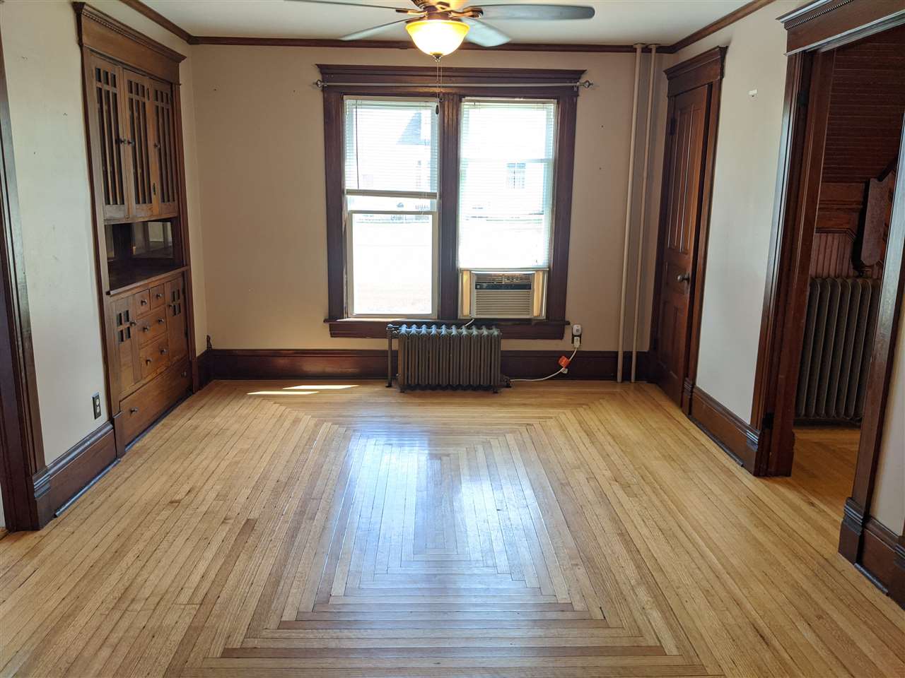 217 South Ridge Street Shannon, IL 61078 - Photo 5 of 26 a view of an empty room with a window and wooden floor