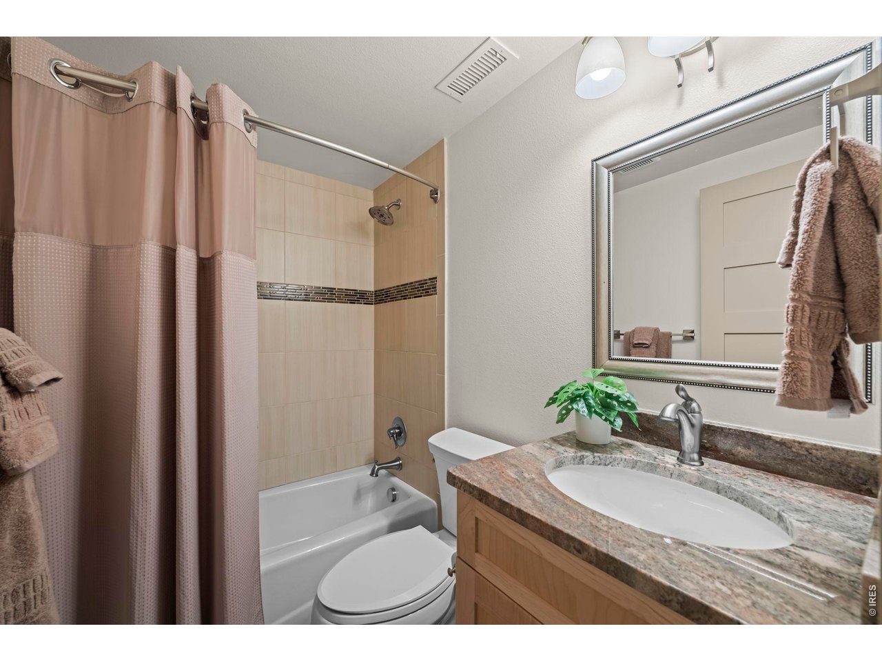 4824 Briar Ridge Court Boulder, CO 80301 - Photo 28 of 40 a bathroom with a granite countertop sink vanity mirror and shower