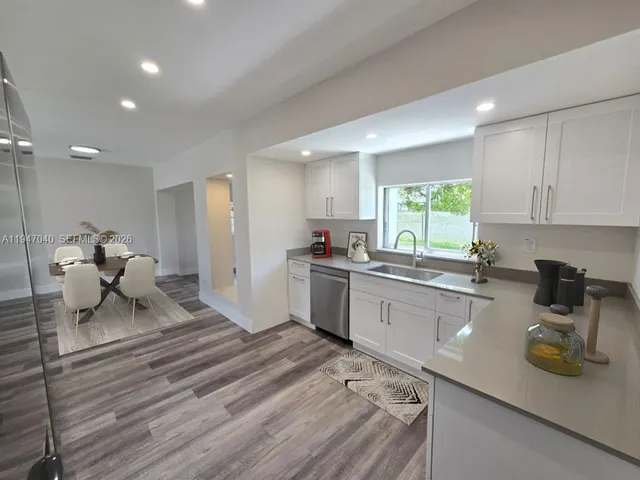 a kitchen with sink refrigerator and window