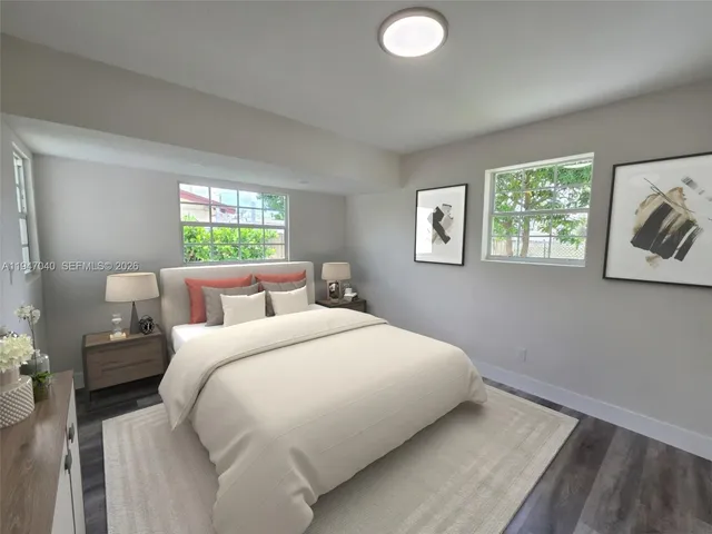 a bedroom with bed and window