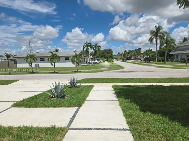 a view of park with multi story residential apartment building in the background