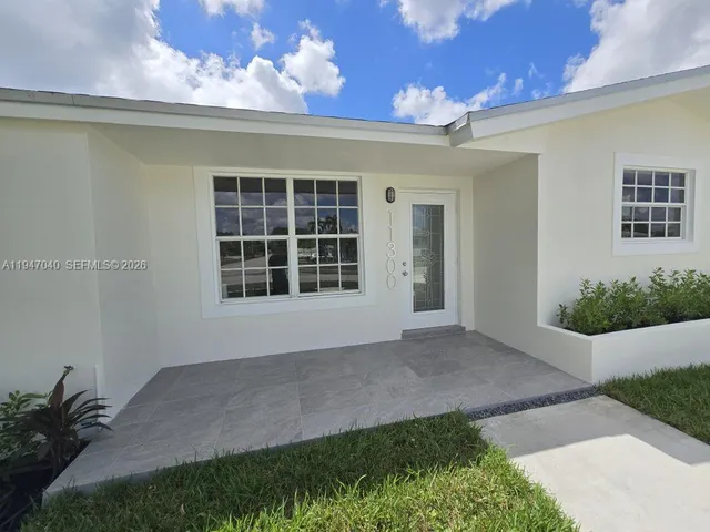 a view of entrance of house and yard with wooden fence