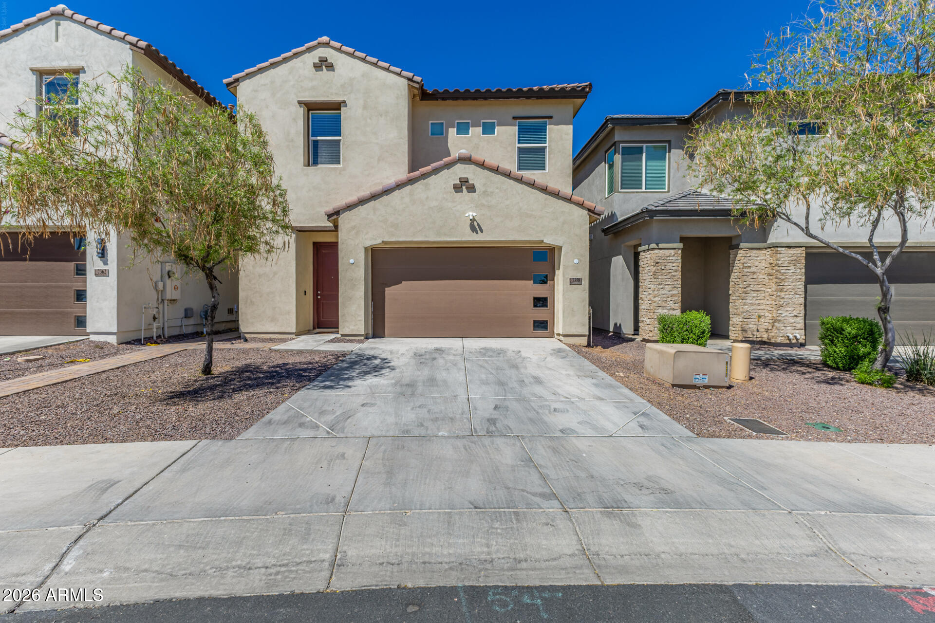 7358 West Phelps Road Peoria, AZ 85382 - Photo 1 of 28 a front view of a house with a yard and garage