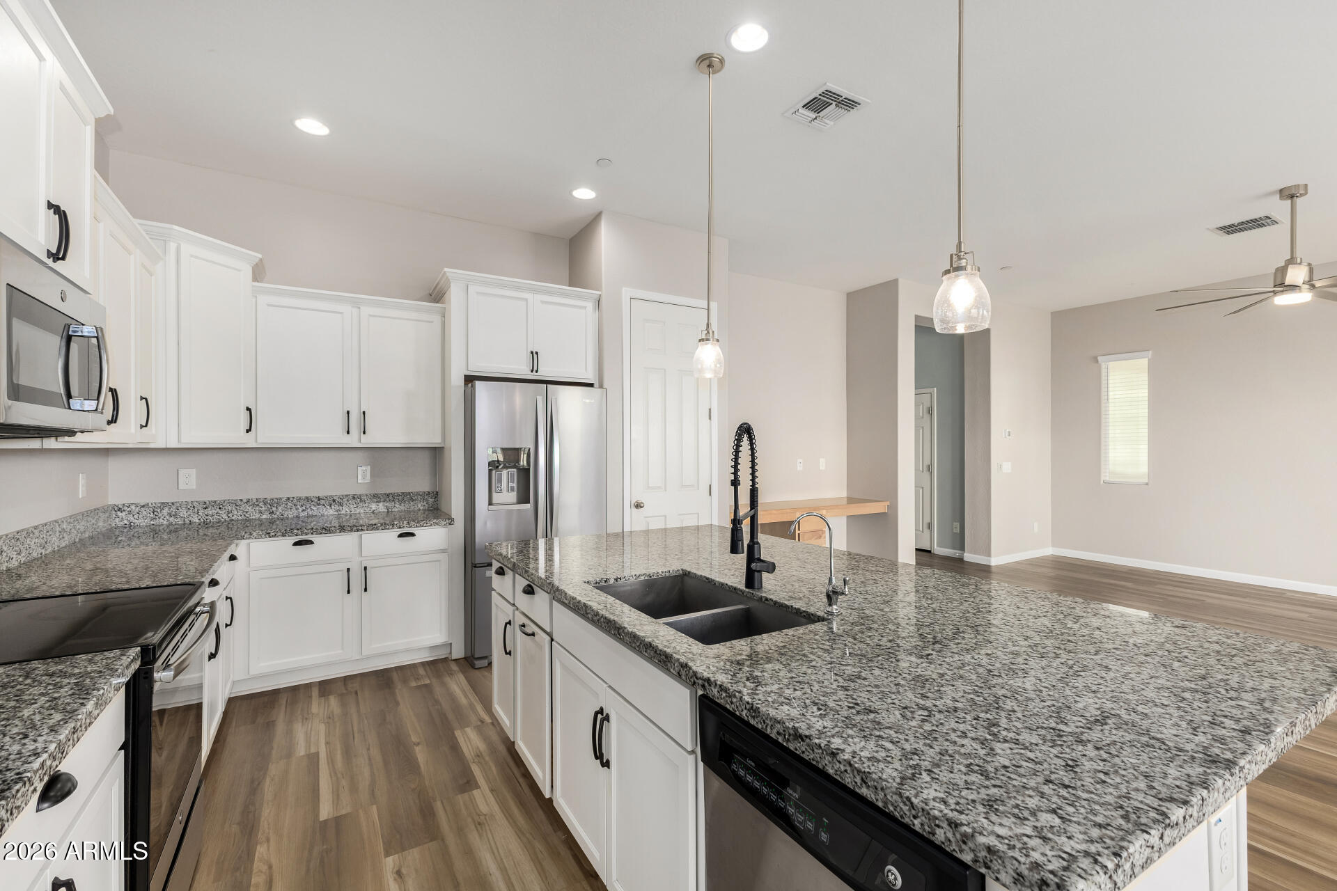 7358 West Phelps Road Peoria, AZ 85382 - Photo 11 of 28 a kitchen with a sink stove and refrigerator
