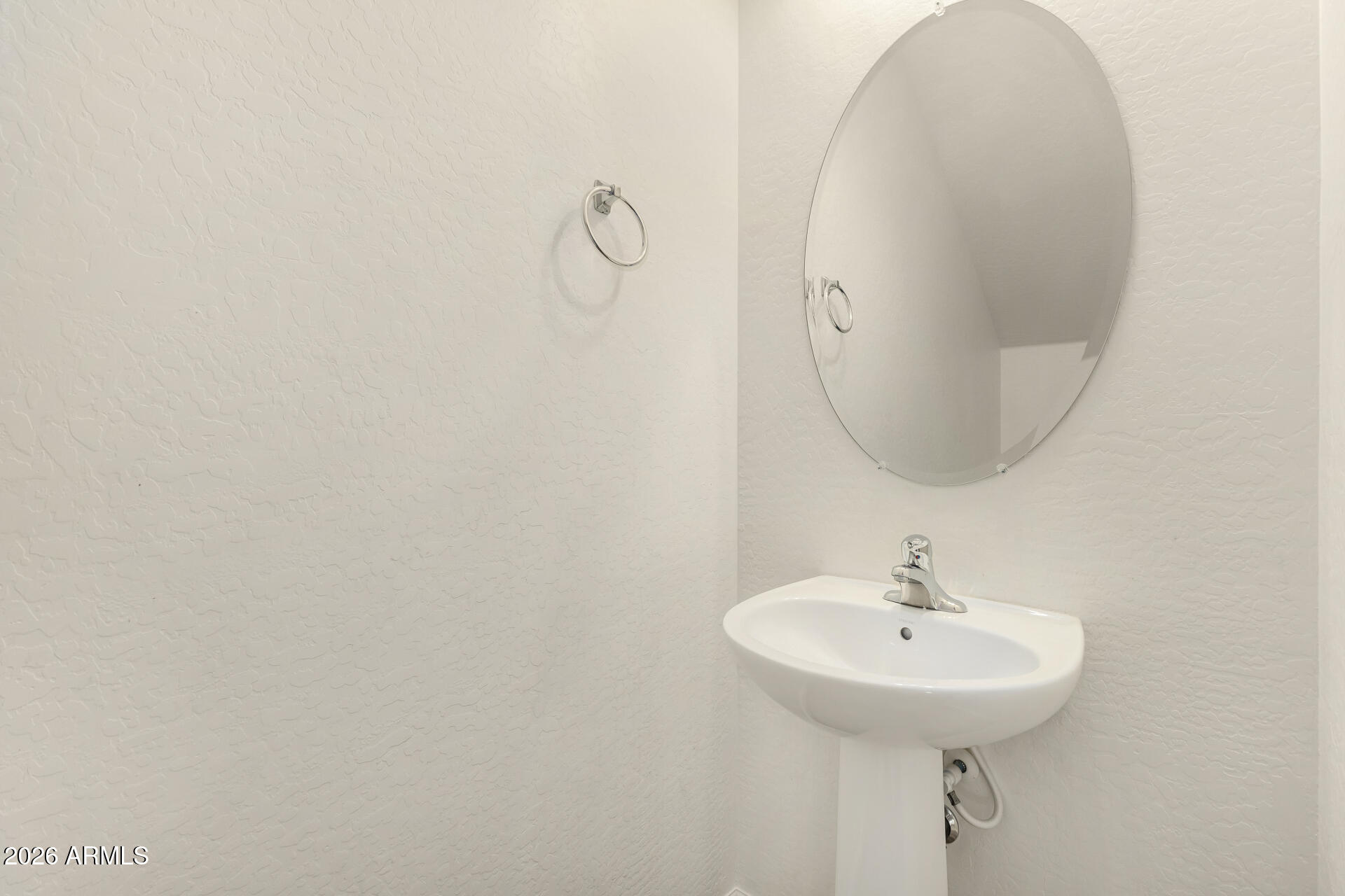 7358 West Phelps Road Peoria, AZ 85382 - Photo 12 of 28 a bathroom with a sink and mirror
