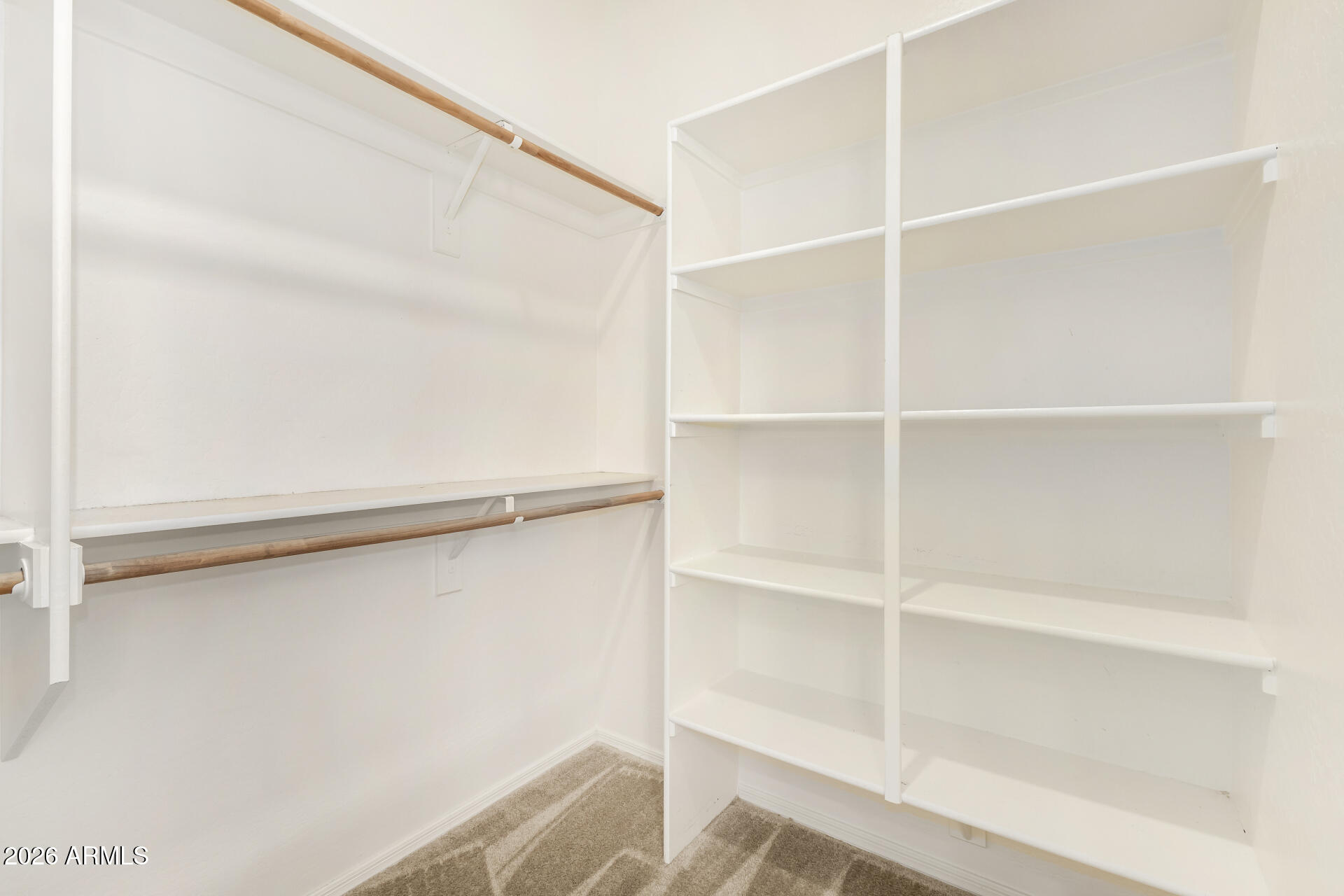 7358 West Phelps Road Peoria, AZ 85382 - Photo 16 of 28 a view of walk in closet with empty racks