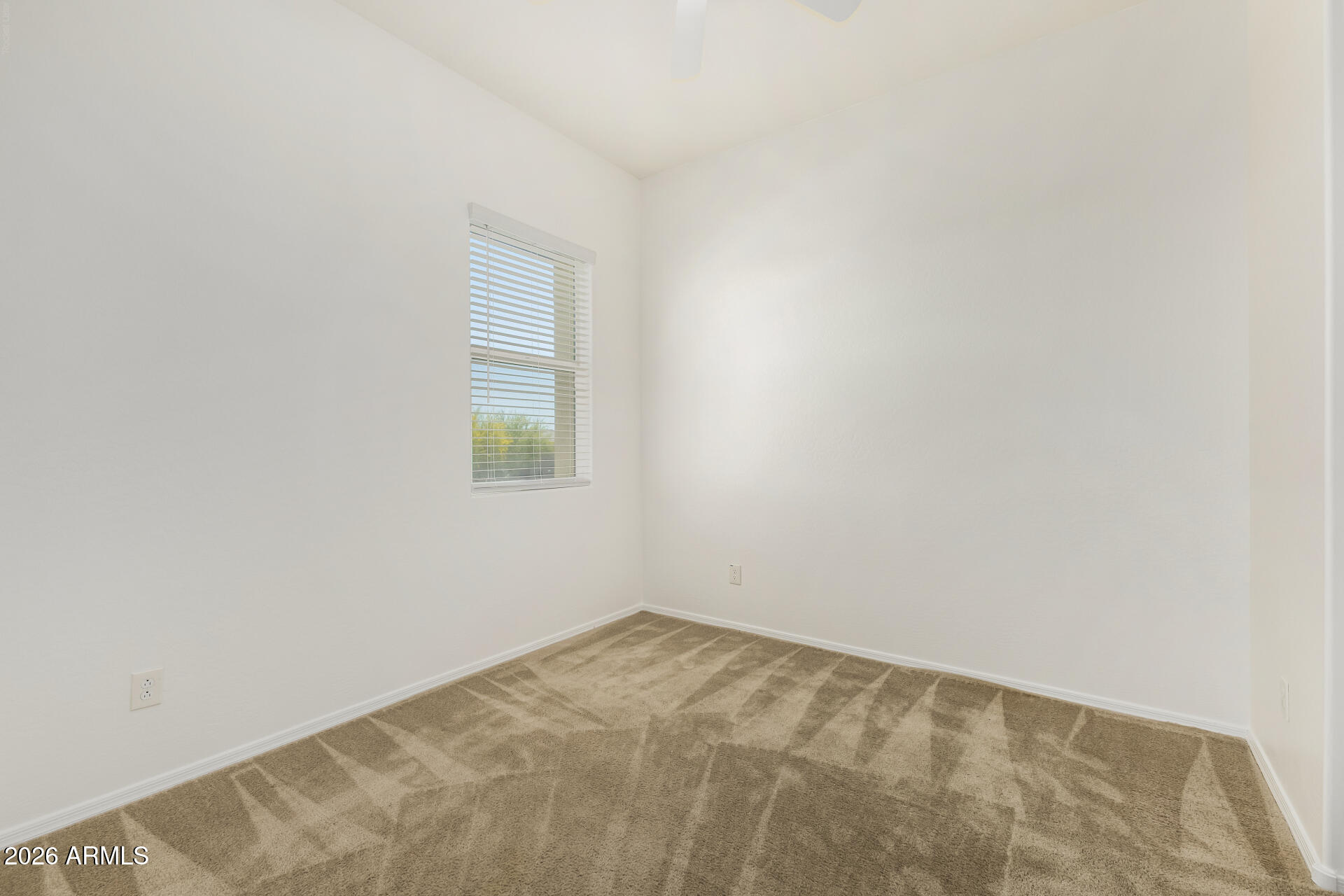 7358 West Phelps Road Peoria, AZ 85382 - Photo 18 of 28 an empty room with a window
