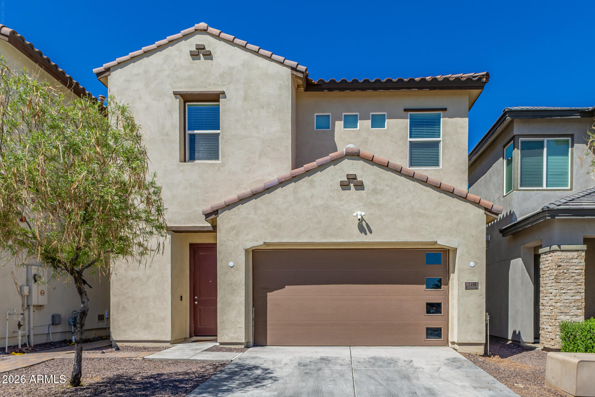 7358 West Phelps Road Peoria, AZ 85382 - Photo 2 of 28 a front view of a house with garage