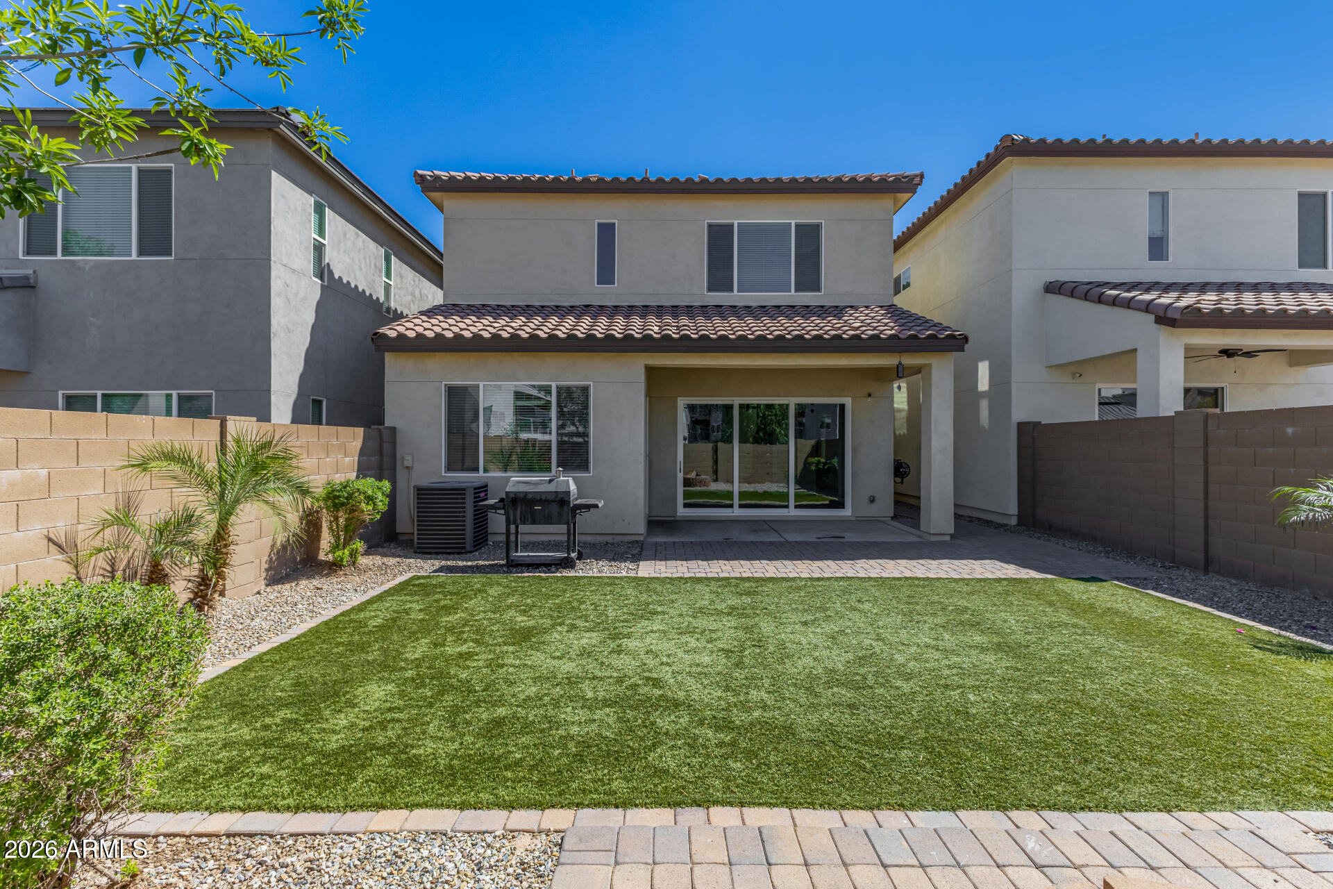 7358 West Phelps Road Peoria, AZ 85382 - Photo 25 of 28 a view of a house with a yard and sitting area
