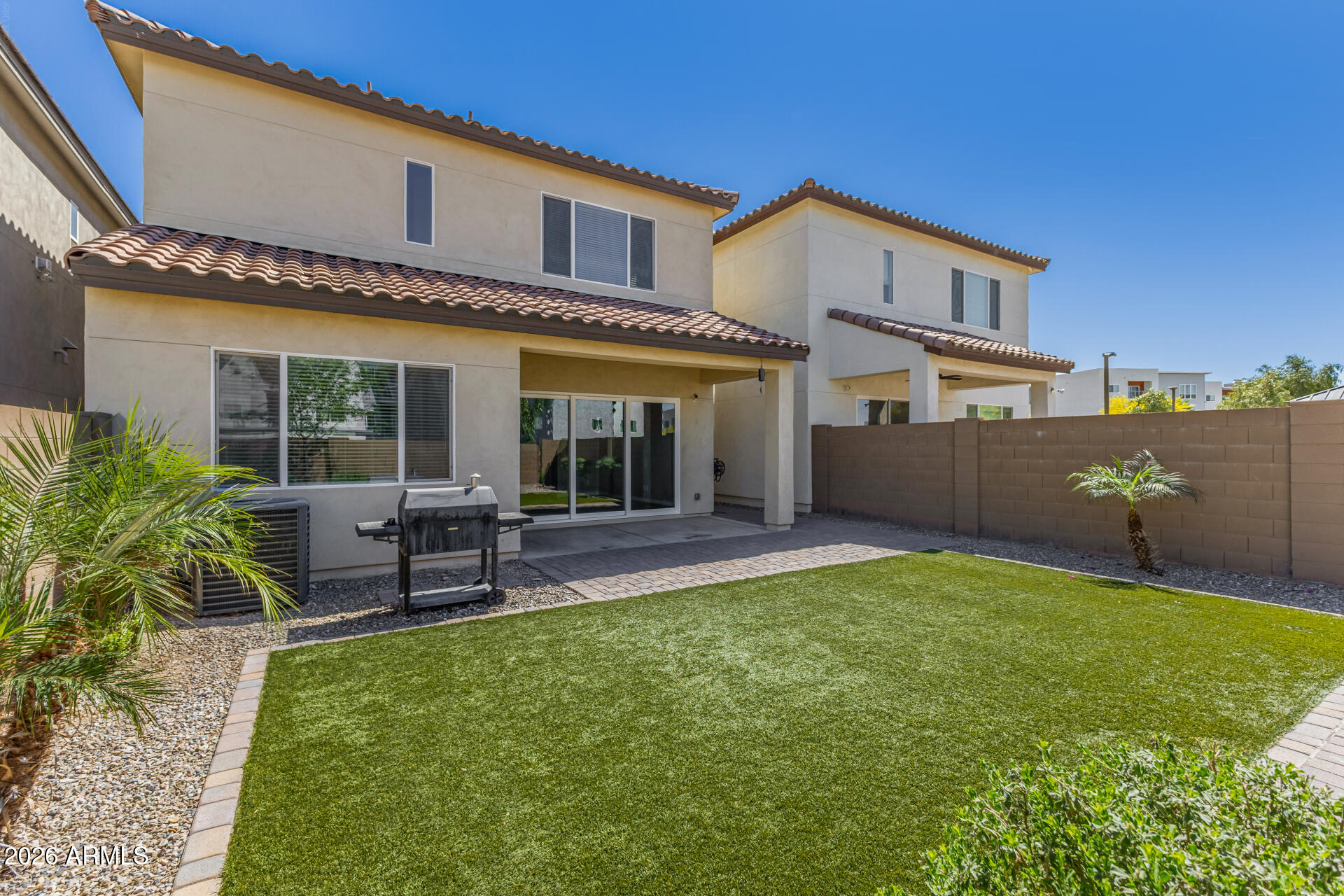 7358 West Phelps Road Peoria, AZ 85382 - Photo 26 of 28 a view of an house with backyard porch and sitting area