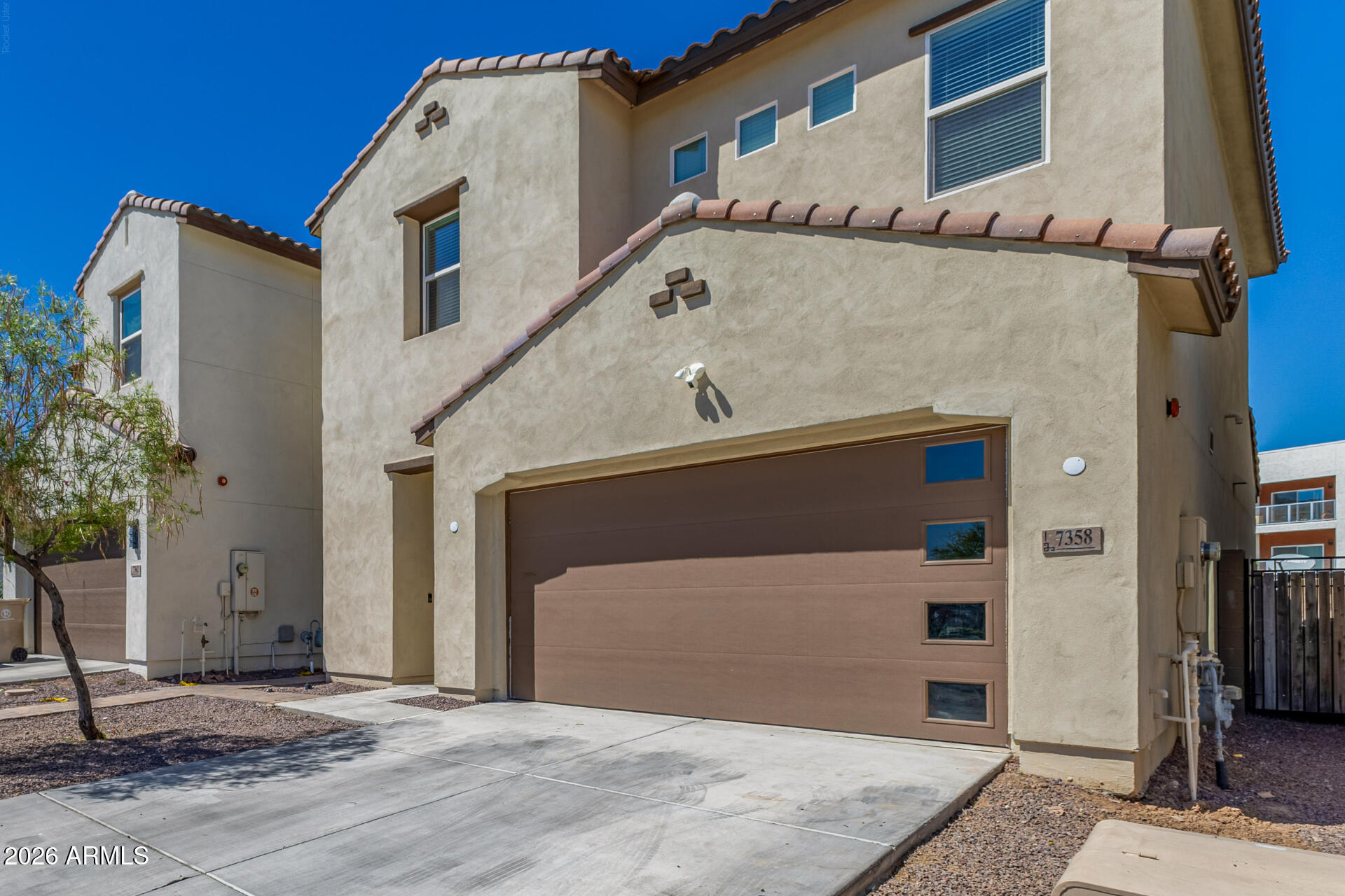 7358 West Phelps Road Peoria, AZ 85382 - Photo 4 of 28 a front view of a house with a garage