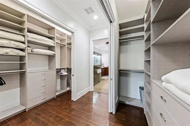 a view of walk in closet with empty racks