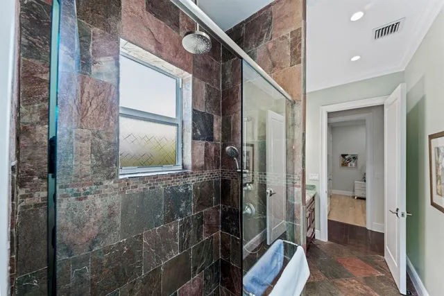 a bathroom with a glass shower door