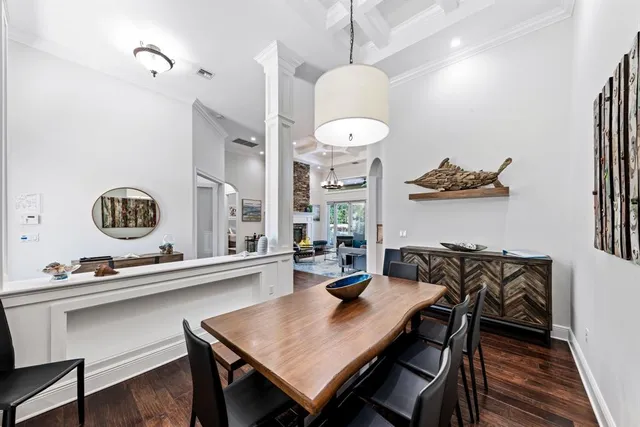 a living room with patio furniture and a floor to ceiling window