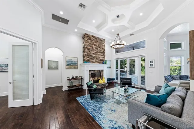 a living room with furniture fireplace and wooden floor