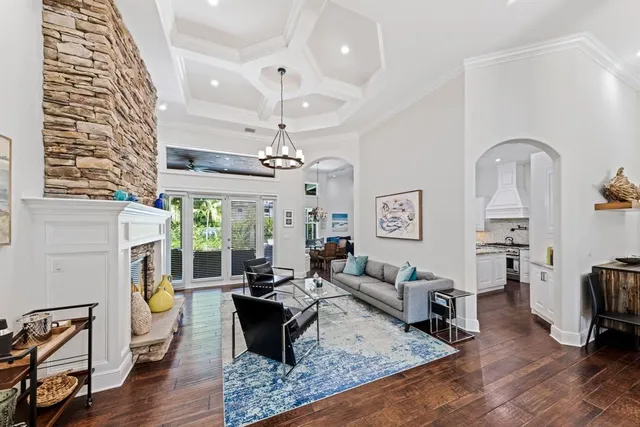 a living room with furniture and a chandelier