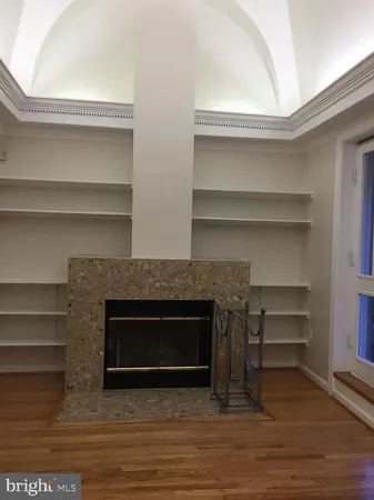 a living room with a fireplace and a walk in closet