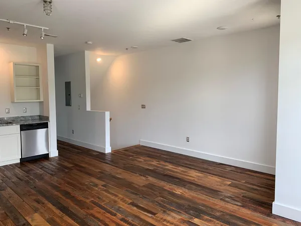 a view of kitchen with granite countertop cabinets and wooden floor