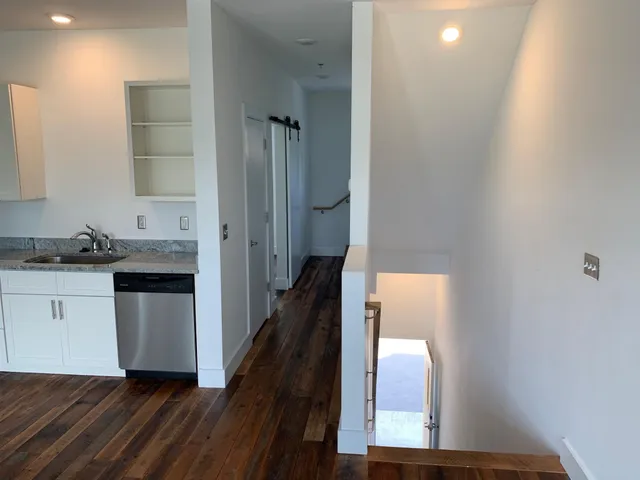 a kitchen with a refrigerator and window