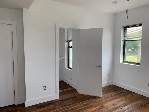 a view of an entryway with wooden floor and door