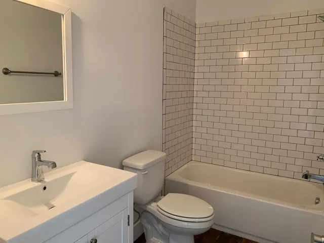 a bathroom with a toilet a sink and bathtub