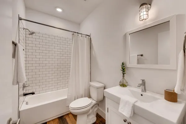 a bathroom with a sink toilet and shower