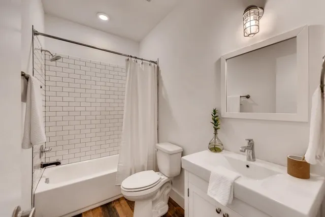 a bathroom with a sink toilet and shower