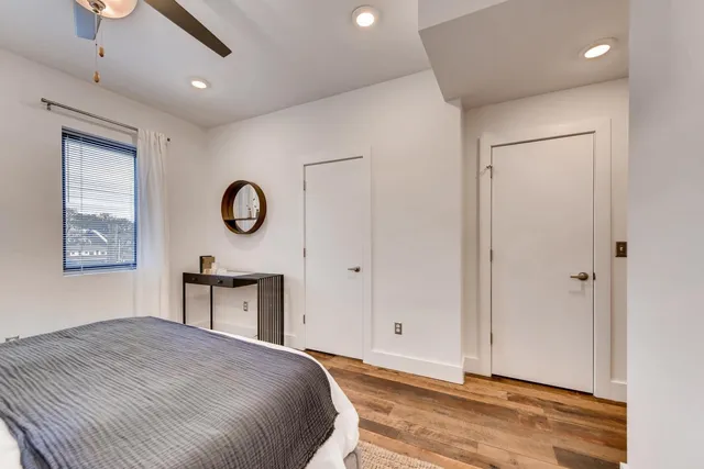 a bedroom with a bed and a window