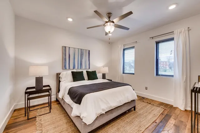 a large bedroom with a bed and a chandelier